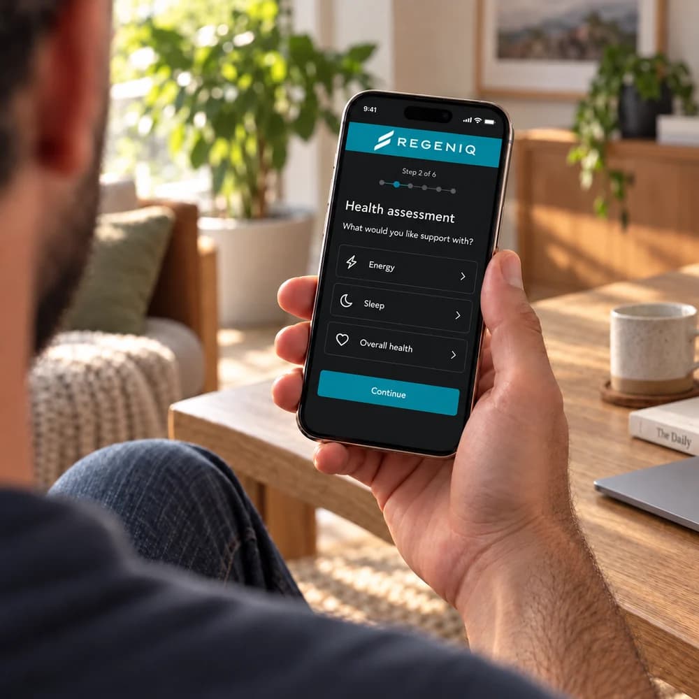 A man holding a phone displaying a health assessment questionnaire at home