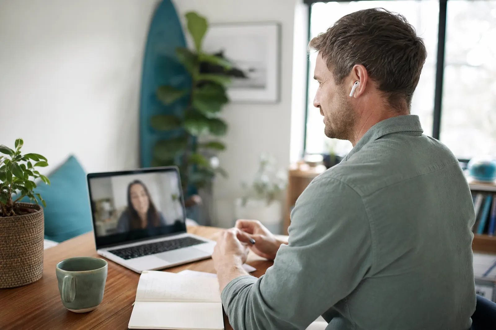 A man on a video call at his desk at home